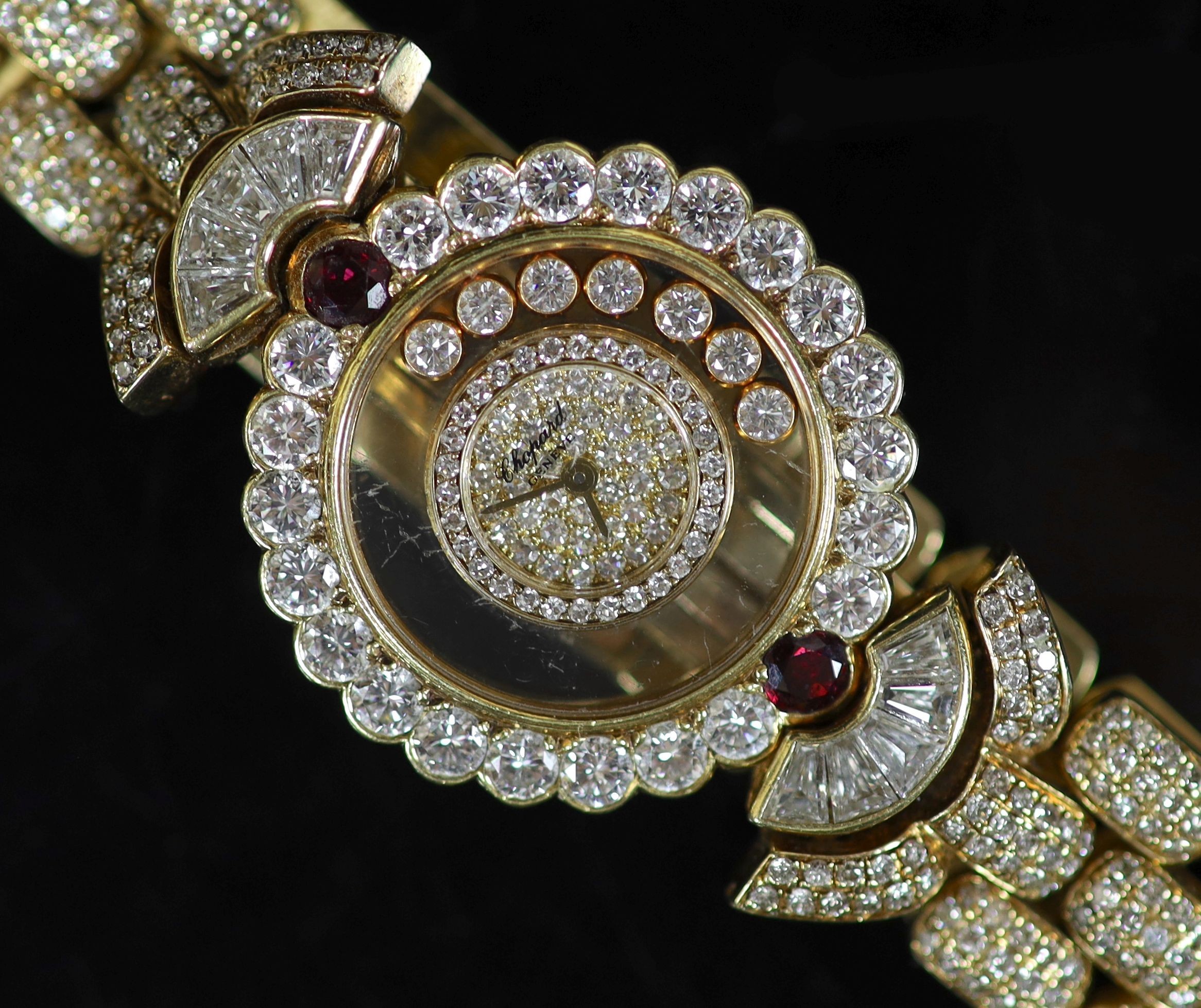 A lady's Chopard 'Happy Diamonds' 18ct gold, ruby and diamond encrusted dress wrist watch